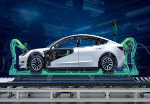 Electric vehicle manufacturing line with robotic arms assembling an EV car, showcasing India’s advanced EV production and clean mobility technology.