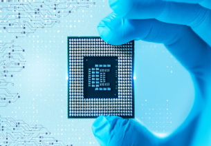 Close-up of a semiconductor chip held with precision gloves, representing India’s growing semiconductor manufacturing ecosystem under the Semicon India Mission.